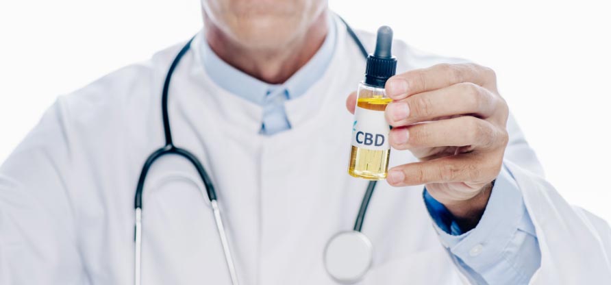Image of a doctor holding forward a bottle of generically labeled CBD oil